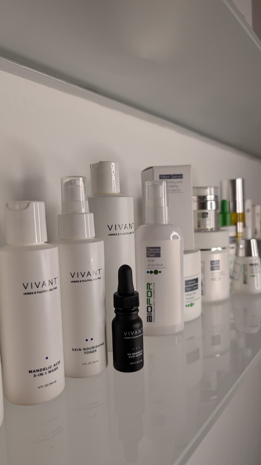 Hautpflegeprodukte von Vivant Skincare und Biofor auf einem Glasregal